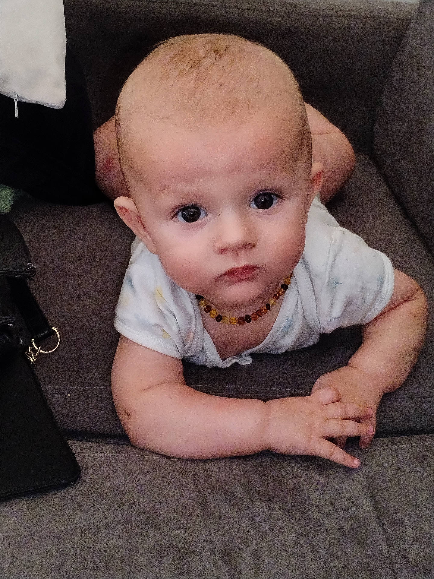 Aaron participe au concours pour gagner de l'argent avec cette photo : accessories, baby, bag, bodypart, chair, couch, crawling, face, finger, furniture, hand, handbag, head, jewelry, necklace, person, photography, portrait, sitting, strap