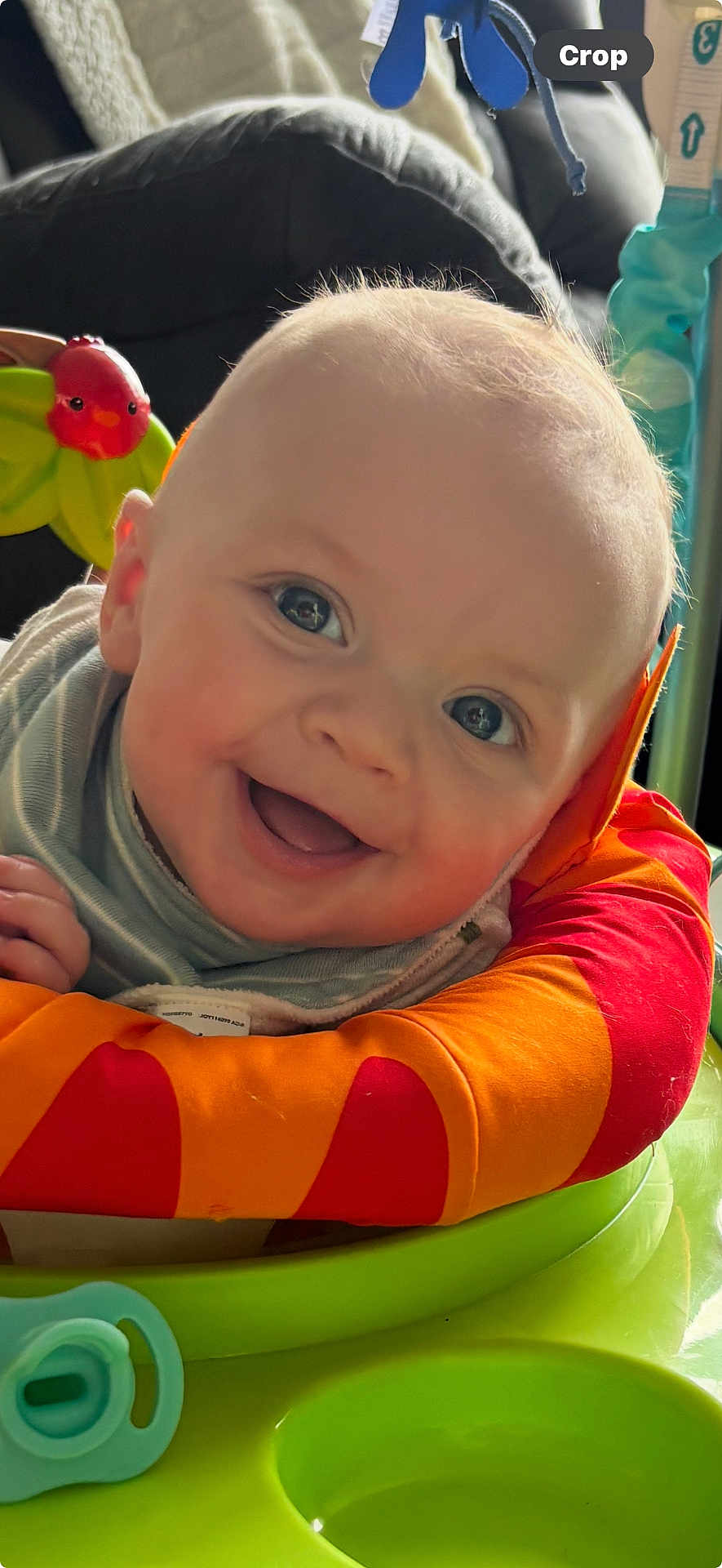 Hayes joined the competition — help win amazing prizes! baby, smiling, face, child, toy, colorful, orange, red, green, play_area, infant, happy, cute, closeup, indoor, padded_ring, pacifier, cheerful, person, young