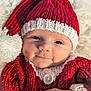 baby, infant, newborn, knit_hat, santa_hat, red_hat, white_trim, blanket, cozy, button, hand, portrait, closeup, blue_eyes, smile, cute, holiday, knitwear, soft_texture, skin