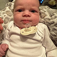 Lottie joined the competition — help win amazing prizes! baby, blanket, candle, closeup, cozy, expression, eyes, face, hand, indoor, infant, mouth, nose, pacifier, person, portrait, skin, smartphone, technology, white_clothing