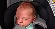Everett joined the competition — help win amazing prizes! newborn, baby, sleeping, infant, car_seat, harness, safety_belt, child, portrait, indoors, vehicle, transportation, striped_outfit, green_clothing, gray_padding, resting, peaceful, closed_eyes, seated, photography