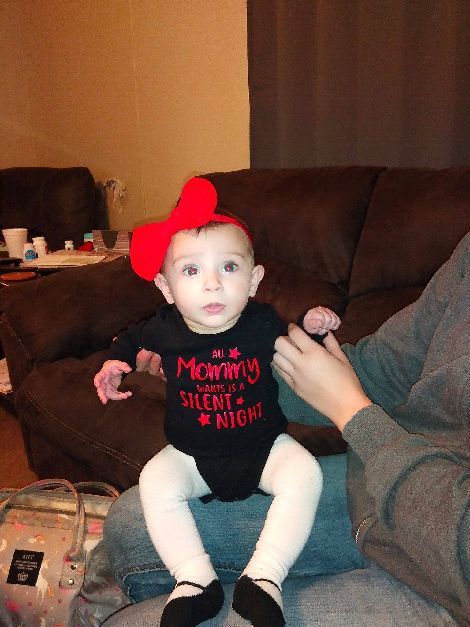 Emma is registered to the contest to win money with this photo: baby, child, furniture, head, headgear, person, sitting, sleeve, surprise, t_shirt, toddler