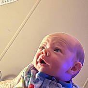 Baylor joined the competition — help win amazing prizes! baby, baby_garment, background, child, colorful_clothing, curious_expression, face, hand, head, human, indoor, infant, lighting, newborn, note, onesie, person, portrait, skin, soft_light
