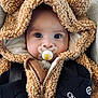baby, pacifier, hoodie, teddy_bear, child, cute, blue_eyes, clothing, warm, seatbelt, car_seat, close_up, infant, face, portrait, soft_texture, expression, adorable, young_child, bundle