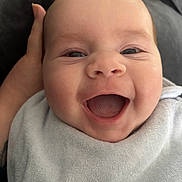 Louie is registered to the contest to win money with this photo: baby, smile, happy, face, infant, closeup, towel, hand, skin, mouth, eyes, expression, cute, child, person, portrait, newborn, joy, head, comfort