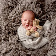 Theo is registered to the contest to win money with this photo: newborn, baby, sleeping, blanket, crocheted_toy, teddy_bear, soft_texture, cozy, wrapped, infant, cute, peaceful, portrait, child, hand, face, knitwear, warm, fuzzy, resting