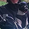 man, dog, motorcycle, helmet, outdoor, pet, animal, rider, black_clothing, glasses, nature, vehicle, adventure, canine, motorbike, happy, helmeted_dog, portrait, travel, fun