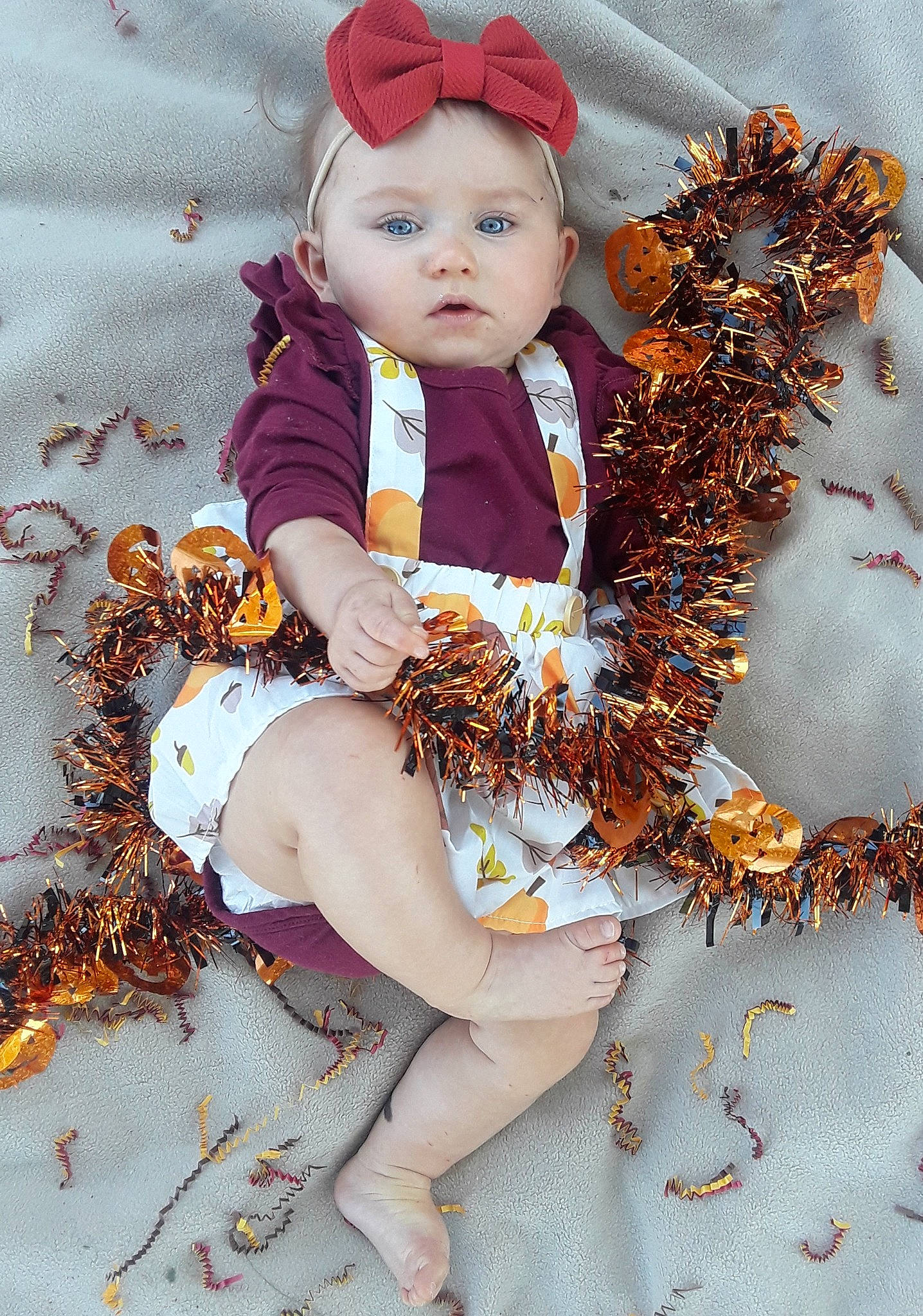 Tinsley is registered to the contest to win money with this photo: autumn, brown_hair, child, costume, doll, fictional_character, headwear, leaf, person, toddler, wig