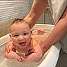 baby, bathtub, bath, water, smile, happy, child, person, skin, arm, hand, indoor, plumbing, support, splash, joy, young, cute, fun, parent