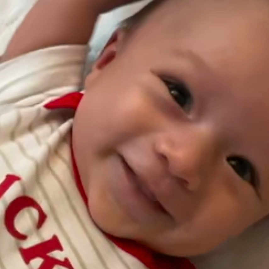 Naran joined the competition — help win amazing prizes! arm, baby, bed, child, clothing, cute, eyes, face, happy, head, infant, lying_down, mickey, mouth, person, portrait, red, skin, smiling, striped_shirt