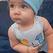 Luca joined the competition — help win amazing prizes! baby, child, birthday, crown, blue_crown, striped_outfit, sitting, couch, navy_blue, curious, wide_eyes, indoors, portrait, infant, cute, small_hands, foot, phone_interface, notification, digital_overlay