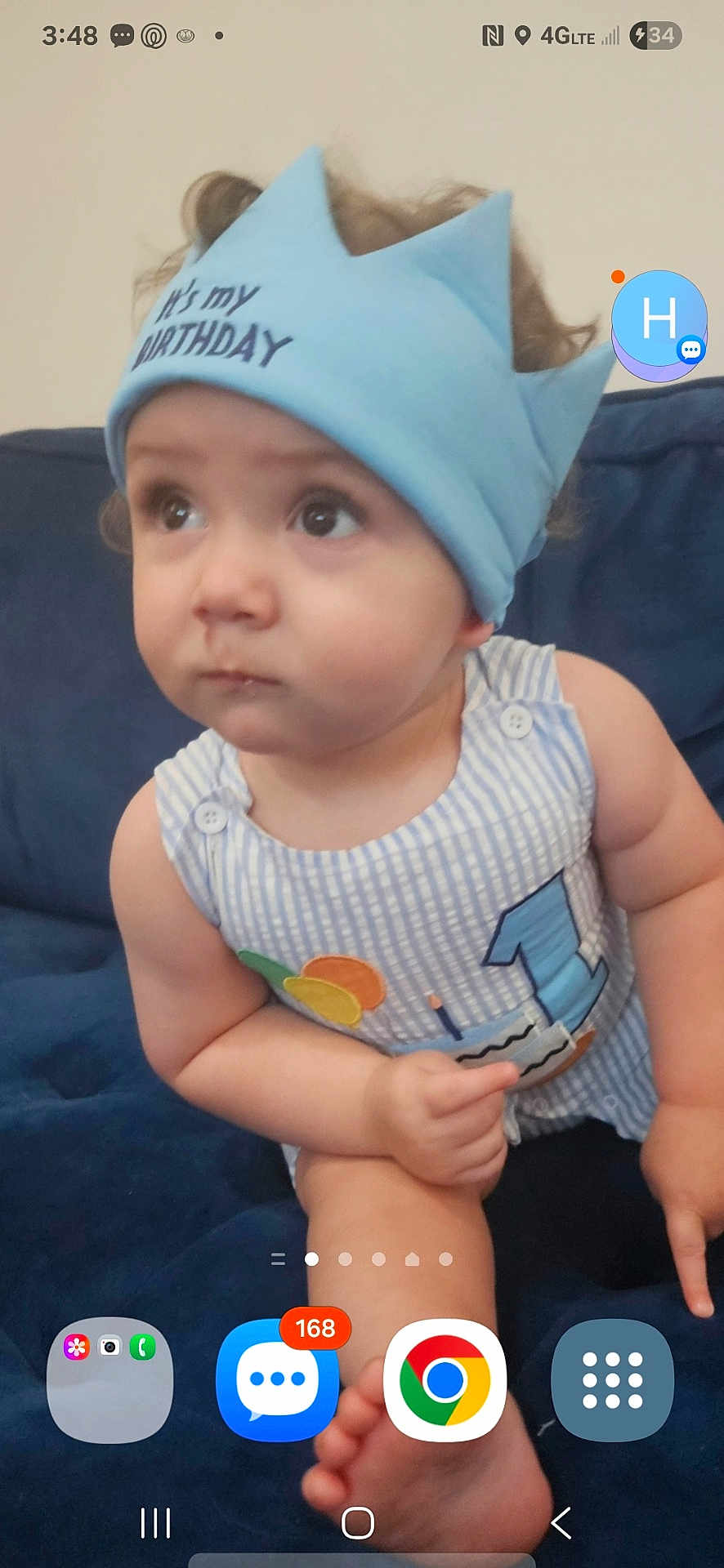 Luca joined the competition — help win amazing prizes! baby, child, birthday, crown, blue_crown, striped_outfit, sitting, couch, navy_blue, curious, wide_eyes, indoors, portrait, infant, cute, small_hands, foot, phone_interface, notification, digital_overlay