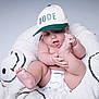 Ethan is registered to the contest to win money with this photo: baby, infant, cap, hat, diaper, cute, smiling, child, foot, hand, skin, furniture, plush, cozy, happy, indoor, portrait, expression, sitting, playful