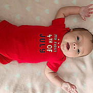 Marlee is registered to the contest to win money with this photo: baby, infant, red_onesie, lying_down, blanket, hearts, cute, child, portrait, soft_texture, expression, small_hands, clothing, indoors, newborn, face, skin, young, person, celebration