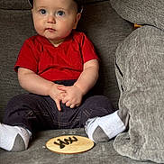 Barrett is registered to the contest to win money with this photo: baby, baseballcap, boy, cap, child, clothing, couch, face, food, furniture, hat, head, homedecor, pants, person, photography, portrait, sitting, sweets, t_shirt
