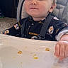toddler, child, high_chair, food_crumbs, indoor, window, smile, face, person, baby_clothes, seatbelt, tray, cute, expression, hair, light, daylight, carpet, furniture, home