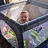 Jaxson is registered to the contest to win money with this photo: baby, playpen, child, indoor, sunlight, window, blanket, toy, dog, smiling, mesh, fabric, furniture, floor, person, happy, standing, daylight, animal, cozy