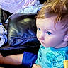baby, toddler, child, car_seat, blanket, blue_eyes, striped_clothing, leather_couch, indoor, curly_hair, sleeping, sitting, person, young_child, casual_clothing, cozy, home, infant, cute, relaxed