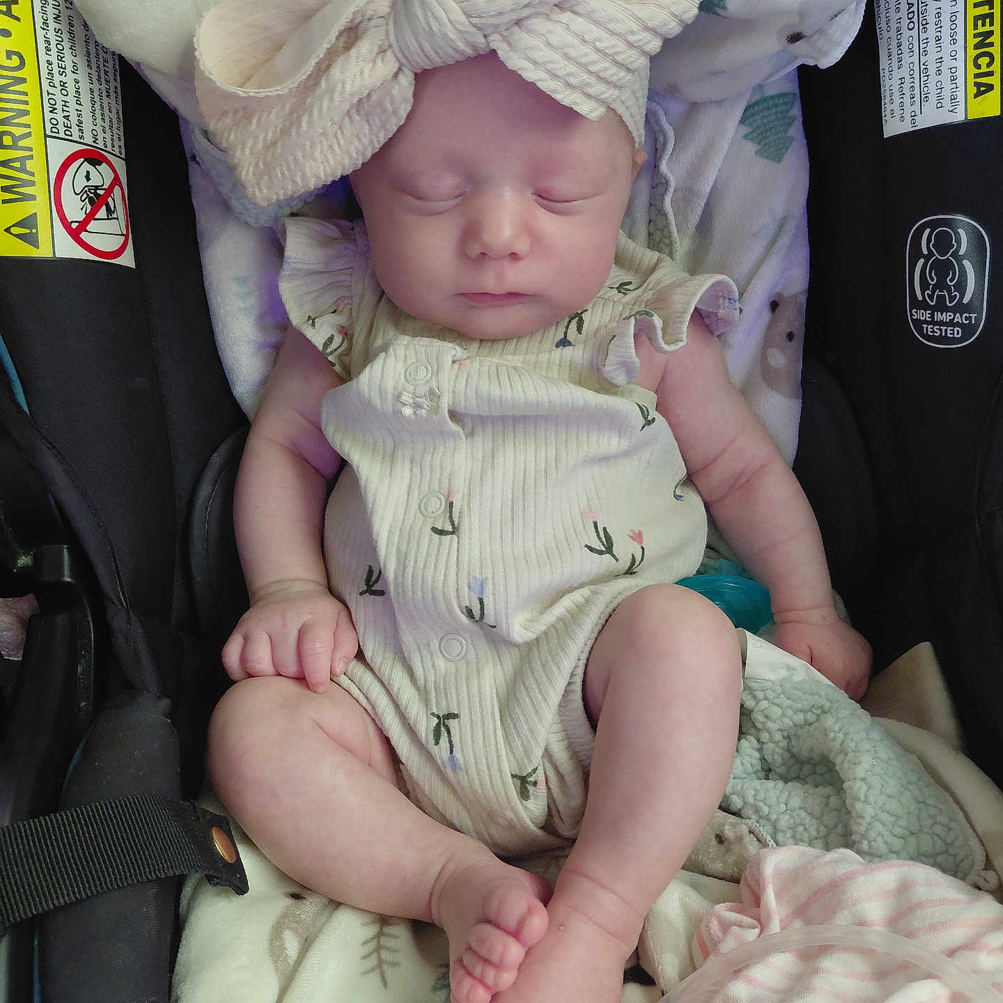 Emma is registered to the contest to win money with this photo: baby, blanket, bow, car_seat, child, clothing, cute, headband, indoor, infant, newborn, onesie, peaceful, person, resting, sleeping, small_feet, small_hands, soft_toys, toddler
