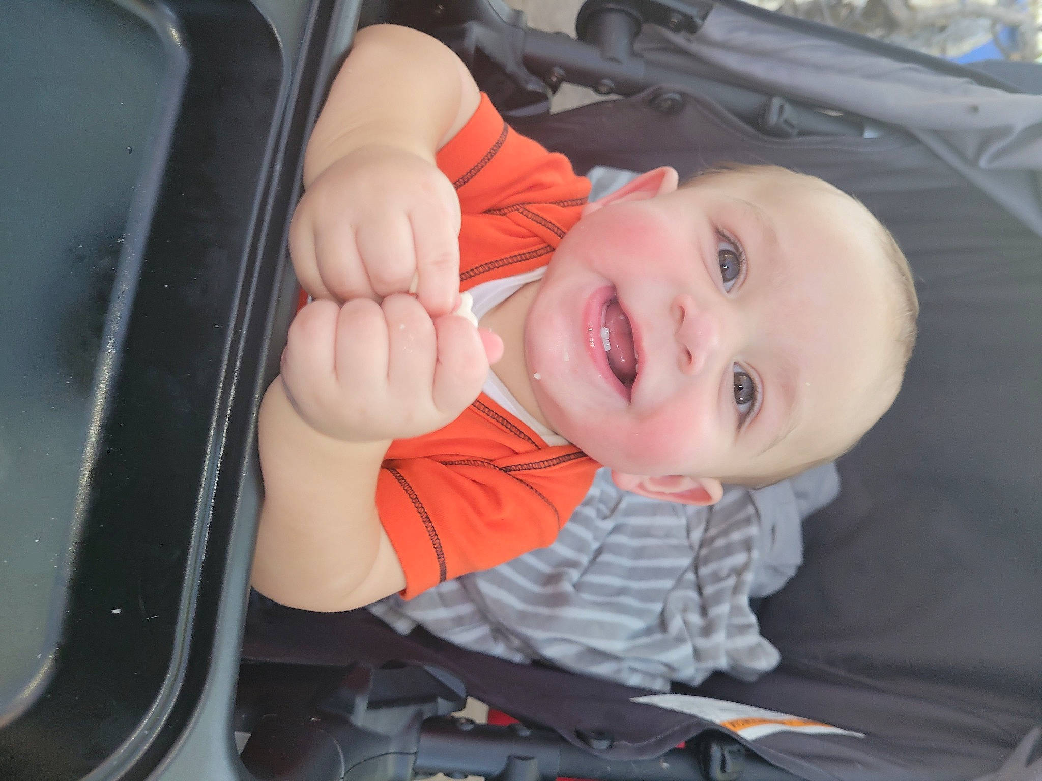 Estevan is registered to the contest to win money with this photo: auto_part, automotive_exterior, automotive_lighting, baby, baby_carriage, baby_products, baby_toddler_clothing, car_seat, child, finger, fun, gesture, happy, mouth, nose, person, skin, smile, thumb, toddler