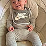 Prestyn is registered to the contest to win money with this photo: baby, infant, smile, bib, nike, clothing, gray_outfit, socks, baby_seat, cushion, happy, cute, indoor, person, child, face, small_hand, footwear, relaxed, portrait