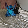 bed, bedroom, blue, cat, cozy, comfort, dark, feline, indoor, light, plush_toy, pillow, quiet, resting, soft, stuffed_animal, toy, white, wall, yellow_light