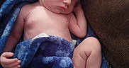 Kayson is registered to the contest to win money with this photo: arms, baby, bare_skin, blanket, blue_blanket, couch, cozy, diaper, face, foot, head, indoors, infant, legs, newborn, peaceful, portrait, resting, sleeping, timestamp
