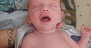 Kayson is registered to the contest to win money with this photo: newborn, baby, infant, sleeping, yawning, portrait, face, eyes_closed, mouth_open, bare_chest, blanket, bed, bedding, adult_hand, tattoo, indoor, home, close_up, candid, timestamp