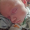 newborn, baby, infant, sleeping, face, close_up, portrait, blond_hair, ear, nose, mouth, cheek, blanket, clothing, indoors, cozy, peaceful, date_stamp, candid, child