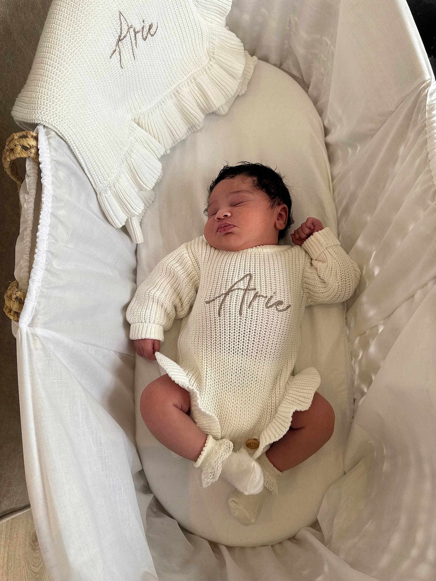Arie-Rae joined the competition — help win amazing prizes! baby, newborn, sleeping, bassinet, white, knitted_outfit, cozy, infant, soft, blanket, socks, cute, peaceful, child, portrait, indoors, resting, toddler, sleep, fabric