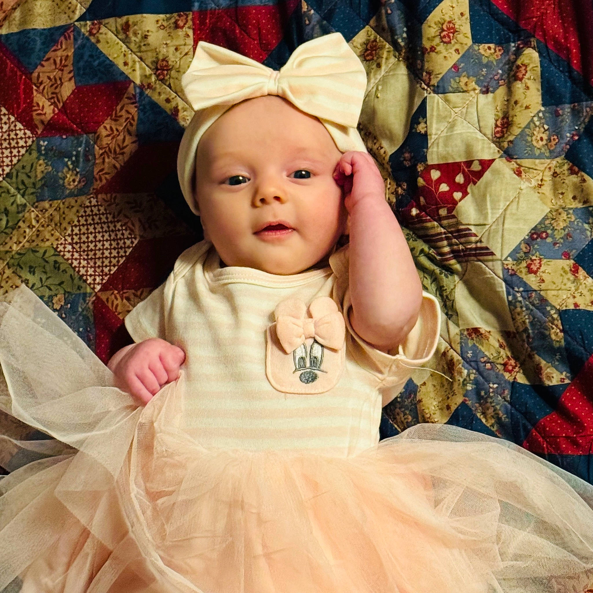 Kelly is registered to the contest to win money with this photo: baby, baby_toddler_clothing, cap, cheek, child, day_dress, dress, fashion_accessory, gown, happy, iris, linens, magenta, outerwear, pattern, person, pink, ruffle, skin, sleeve