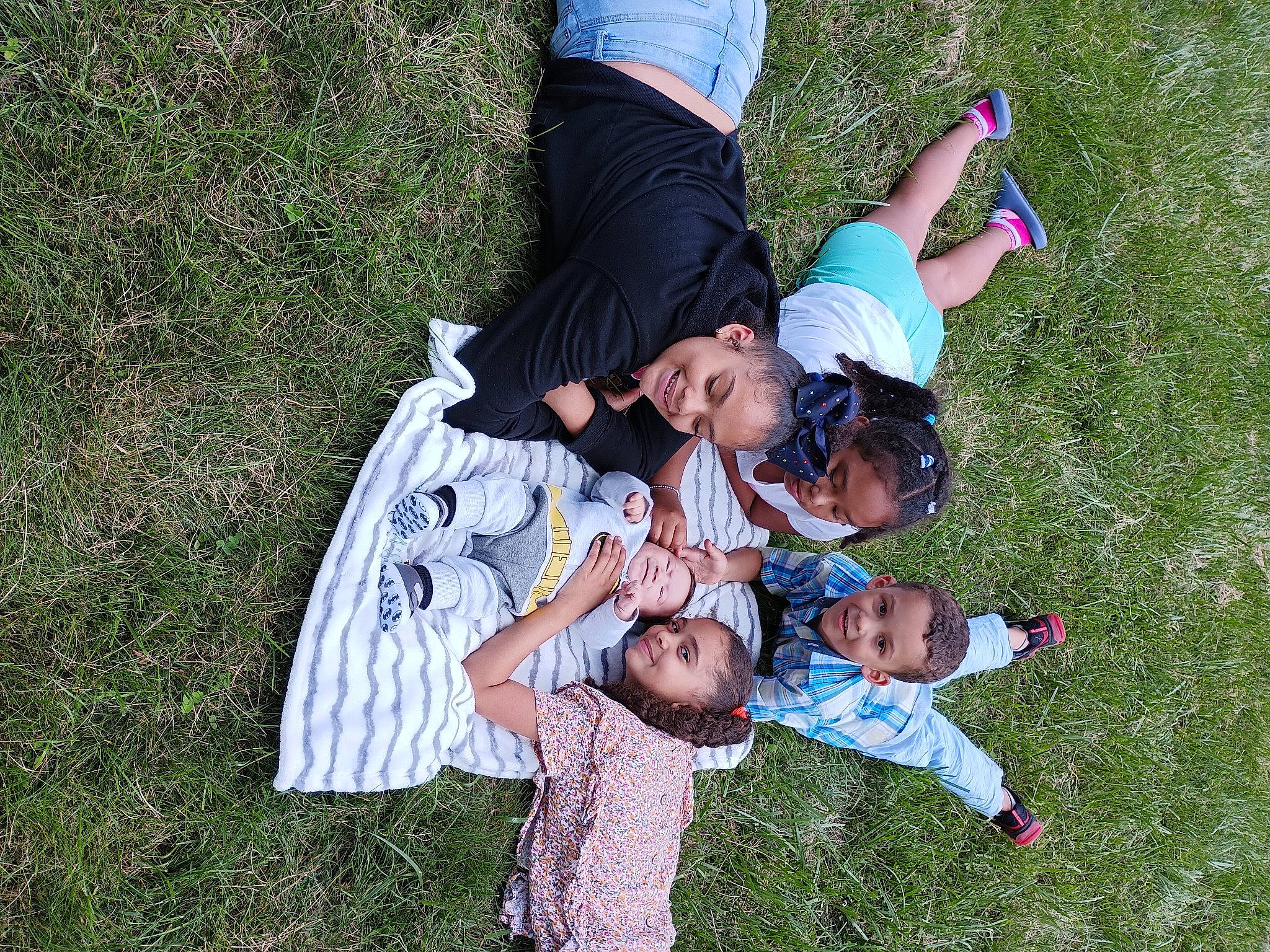 Aydin joined the competition — help win amazing prizes! arm, botany, child, event, fun, gesture, grass, grass_family, grassland, happy, joy, lawn, leisure, meadow, natural_environment, people_in_nature, person, plant, recreation, smile