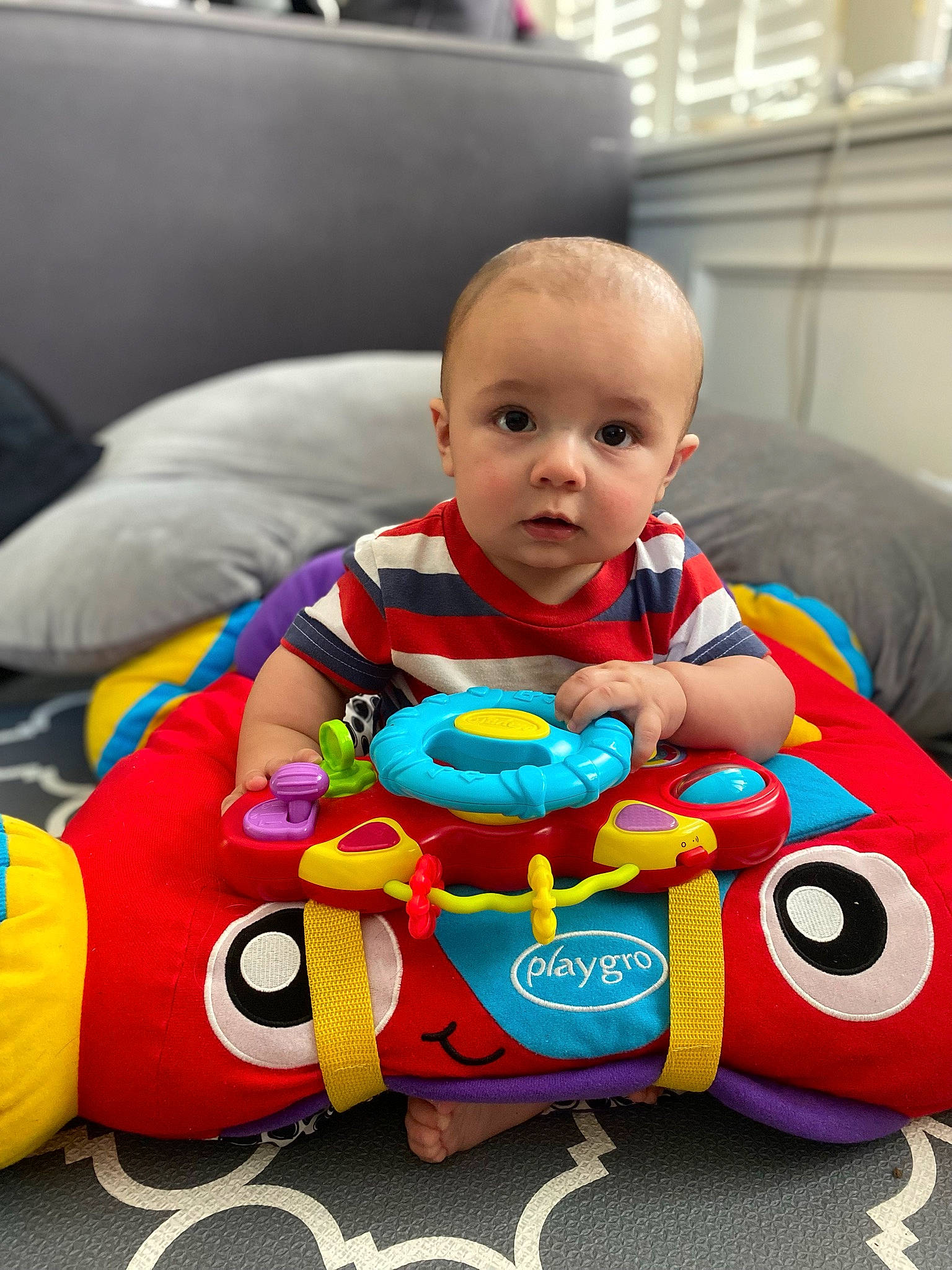 Jaxon is registered to the contest to win money with this photo: baby, baby_playing_with_toys, baby_products, baby_toddler_clothing, baby_toys, child, comfort, couch, face, fictional_character, flooring, fun, happy, person, play, sitting, stuffed_toy, t_shirt, toddler, toy