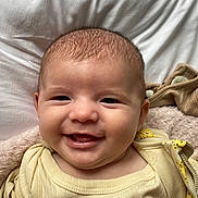 Eliora joined the competition — help win amazing prizes! baby, child, closeup, clothing, cute, eyes, face, happy, head, infant, lying_down, mouth, person, portrait, skin, smile, soft, texture, warm, yellow