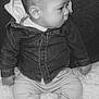 baby, infant, child, denim_jacket, pants, socks, couch, fluffy_rug, side_profile, seated, indoor, clothing, cute, portrait, young_child, looking_away, monochrome, black_and_white, soft_texture, casual