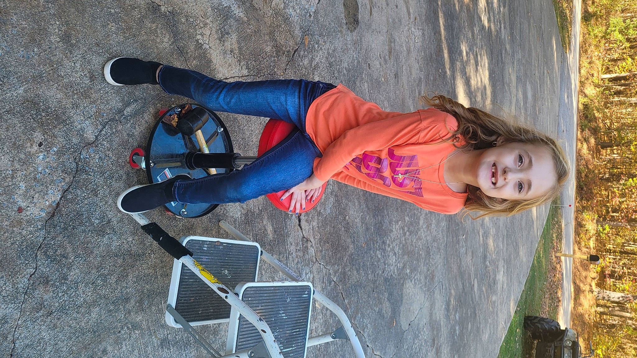 Brielle is registered to the contest to win money with this photo: boot, carmine, denim, electric_blue, fun, human_leg, jeans, joy, knee, leisure, person, recreation, sandal, sitting, sportswear, t_shirt, thigh, tire, trunk, waist