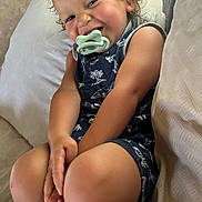 Giovanni joined the competition — help win amazing prizes! toddler, child, smiling, pacifier, curly_hair, sitting, couch, cushion, indoor, happy, casual_clothing, shorts, sleeveless_shirt, skin, person, portrait, young_child, relaxed, cute, baby