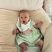 Ruby-Mae joined the competition — help win amazing prizes! baby, bib, child, comfort, cushion, cute, dress, expression, feet, green, hands, indoor, infant, open_mouth, person, pink, soft_furniture, striped_clothing, white, wide_eyes