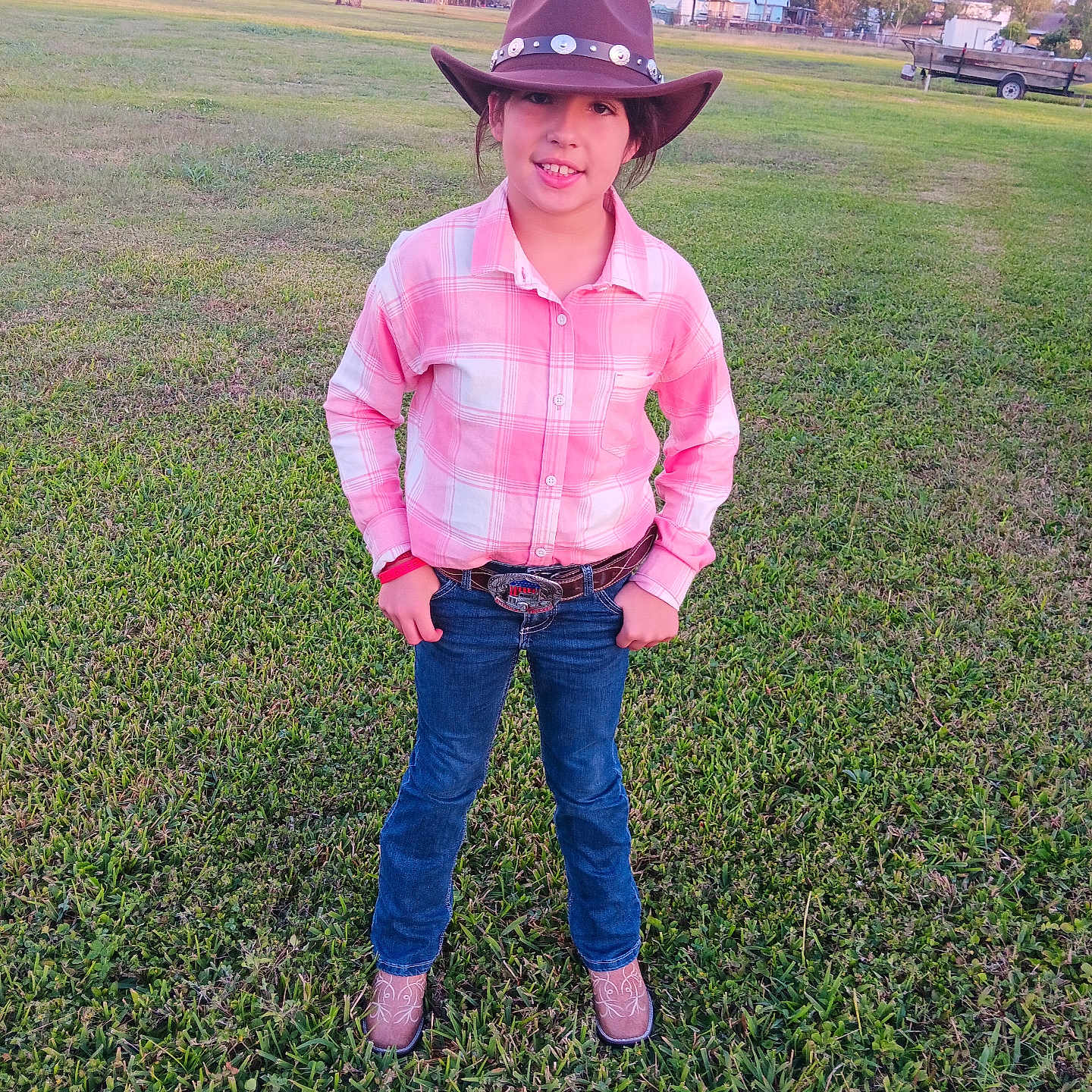 Braylie is registered to the contest to win money with this photo: boy, car, child, clothing, cowboyhat, face, footwear, grass, hat, head, jeans, machine, male, pants, person, plant, shoe, sunhat, transportation, wheel