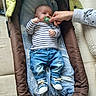 baby, infant, pacifier, hand, clothing, striped_shirt, denim_jeans, blue_shoes, baby_carrier, blanket, cushion, indoor, person, cute, child, relaxing, resting, small, newborn, comfort