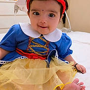 Wahenoor joined the competition — help win amazing prizes! baby, child, costume, dress, headband, red_bow, blue_top, yellow_skirt, barefoot, indoor, bed, smiling, cute, portrait, tulle, white_collar, infant, happy, small_toes, playful