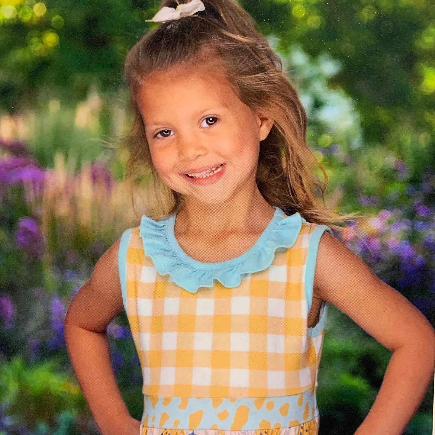 Timber Mae is registered to the contest to win money with this photo: blouse, brownhair, child, clothing, dress, face, female, flower, girl, grass, hair, happy, head, outdoors, person, photography, plant, portrait, purple, smile