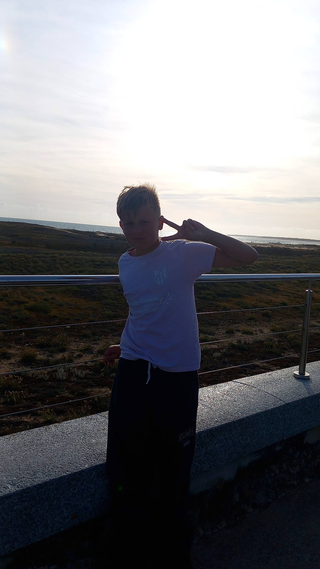 Théo participe au concours pour gagner de l'argent avec cette photo : asphalt, cloud, evening, flash_photography, gesture, grassland, happy, horizon, landscape, leisure, ocean, person, road, rock, shadow, sitting, sky, sunset, t_shirt, tints_and_shades