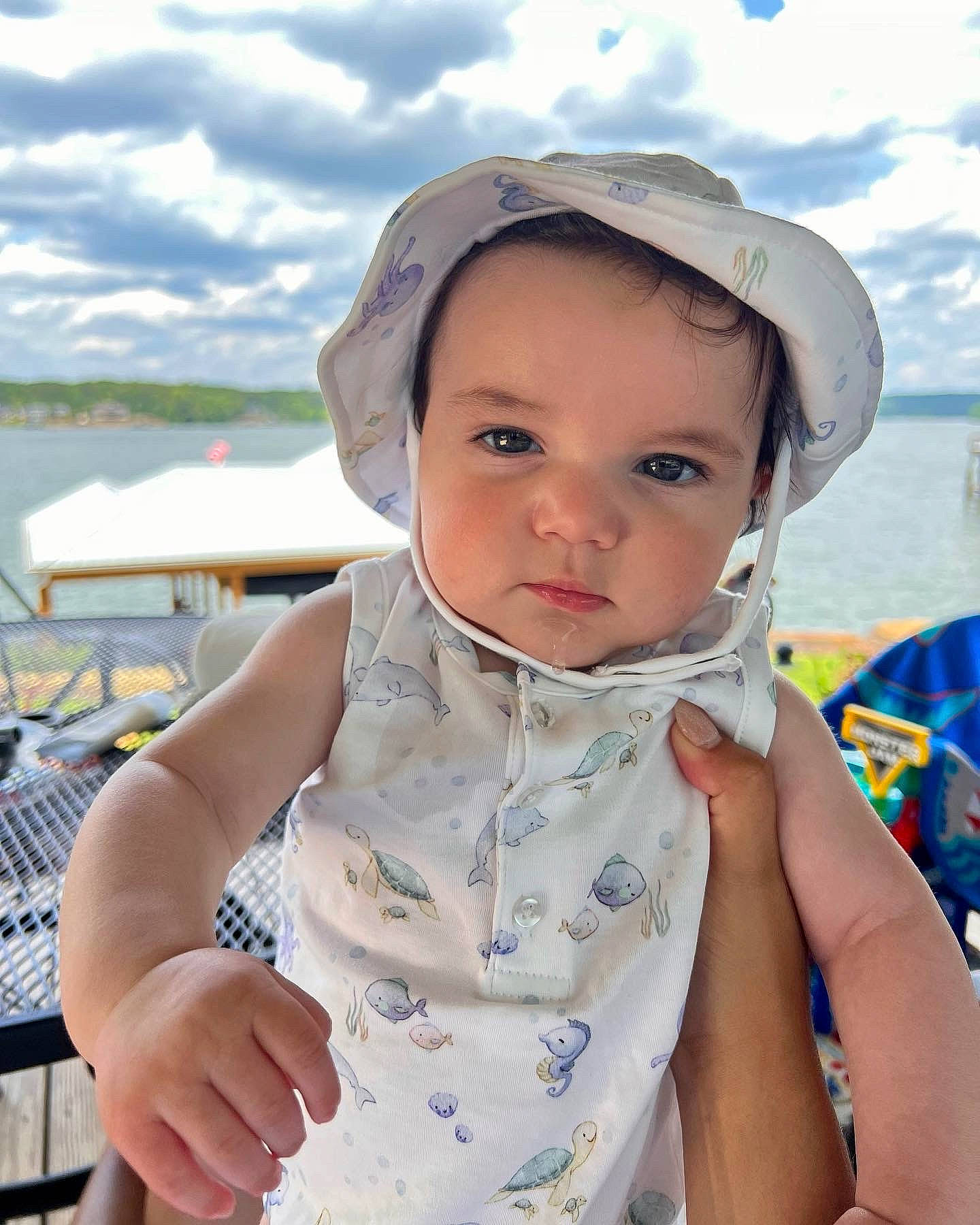 Banks is registered to the contest to win money with this photo: baby, baby_toddler_clothing, baseball_cap, cap, child, cloud, dress, fun, happy, hat, headwear, leisure, lip, person, personal_protective_equipment, recreation, skin, sky, sleeve, sun_hat