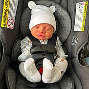 Cooper joined the competition — help win amazing prizes! newborn, baby, infant, car_seat, hat, socks, sleeping, straps, gray, clothing, safety, warning_label, cute, child, seat, infant_seat, baby_clothes, cozy, peaceful, nap