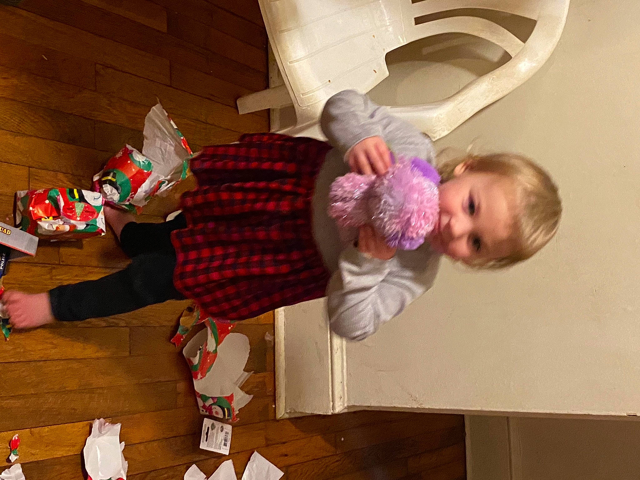 Nevaeh is registered to the contest to win money with this photo: baby, carmine, child, christmas, comfort, event, floor, flooring, fun, holiday, human_leg, lap, pattern, person, plaid, room, smile, sock, thigh, toddler
