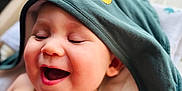 Manoa participe au concours pour gagner de l'argent avec cette photo : baby, child, smiling, happy, hood, clothing, face, skin, infant, portrait, cute, expression, laughing, indoors, toddler, headwear, closeup, soft_light, blanket, relaxed