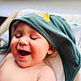 baby, child, smiling, happy, hood, clothing, face, skin, infant, portrait, cute, expression, laughing, indoors, toddler, headwear, closeup, soft_light, blanket, relaxed