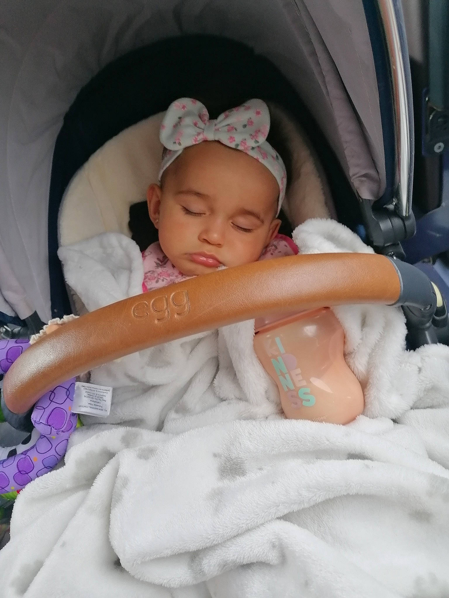 Milana is registered to the contest to win money with this photo: baby, baby_products, baby_toddler_clothing, car_seat, child, comfort, event, fashion_accessory, fun, happy, hat, headband, headgear, headpiece, headwear, linens, person, pink, room, sitting