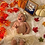 baby, infant, tutu, headband, smiling, laughing, autumn, fall_leaves, orange_lights, knitted_pumpkin, cream_blanket, decor, cute, happy, soft_texture, celebration, festive, child, portrait, cozy
